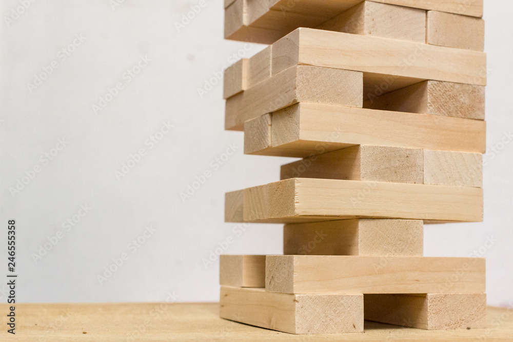 Board game jenga. Wooden blocks. A logic game for two and a company. Entertainment for adults and children. Useful leisure. Educational toys. Wooden bricks. Tower of cubes. Board game jenga. Wooden blocks. A logic game for two and a company. Entertainment for adults and children. Useful leisure. Educational toys. Wooden bricks. Tower of cubes.