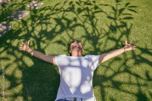 Man enjoying in summertime on a grass field. photo