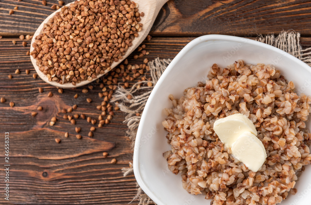 Buckwheat porridge with butter on dark wooden background. Buckwheat porridge with butter on dark wooden background.