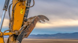 Excavator arm against mountain and sky in Utah