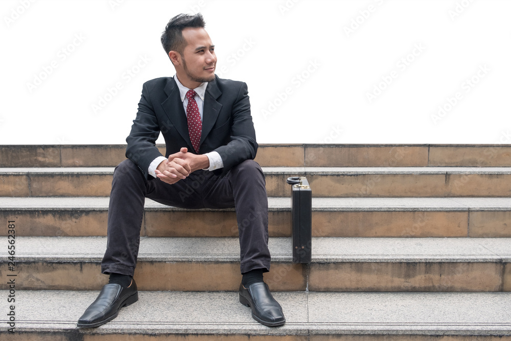 Young businessman jobless sitting on stair in the city Young businessman jobless sitting on stair in the city