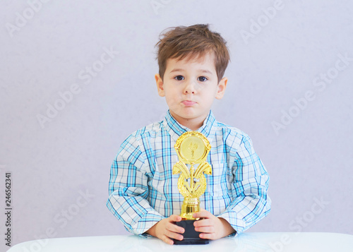 sad boy who won the achievement prize but upset. high demands on the child