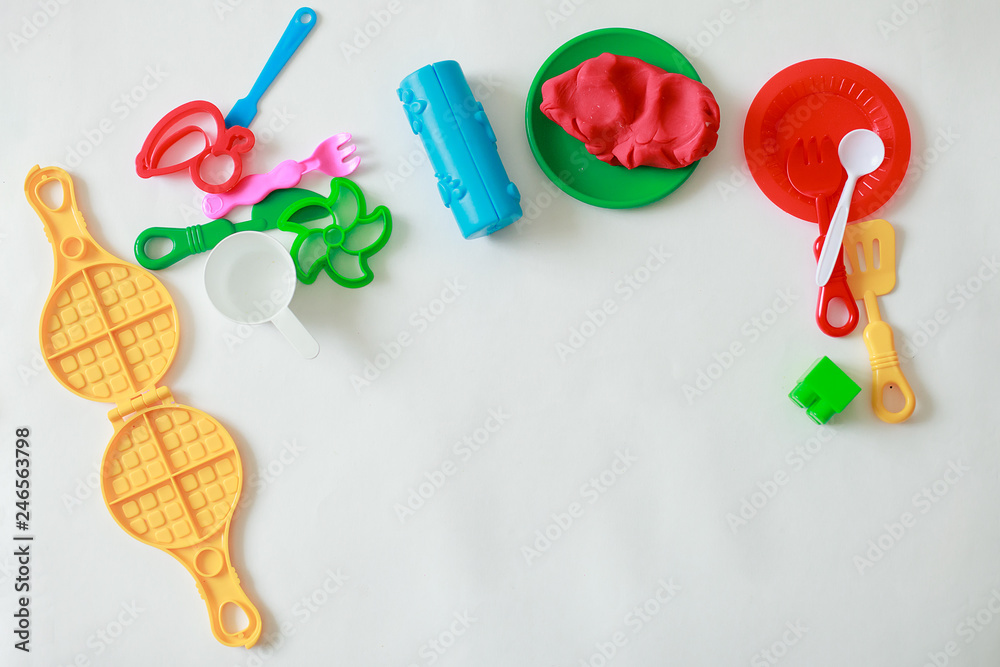 Set of play dough and plastic cutting block and other tools on white background, concept of handcraft kindergarten activity Set of play dough and plastic cutting block and other tools on white background, concept of handcraft kindergarten activity