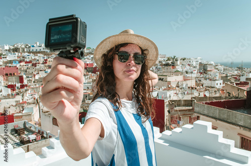 Young happy woman taking selfie on the terrace. Tourist enjoying a vacation in Tangier, Morocco