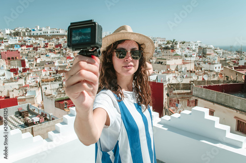 Young happy woman taking selfie on the terrace. Tourist enjoying a vacation in Tangier, Morocco