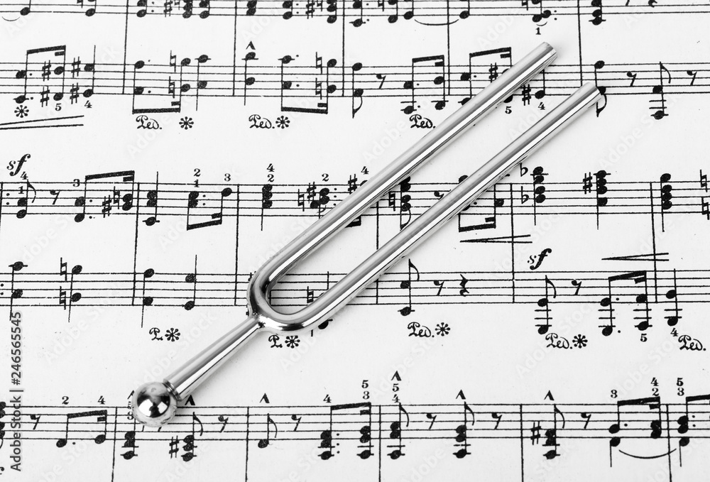 Fototapeta premium Pitchfork on sheet music - art background