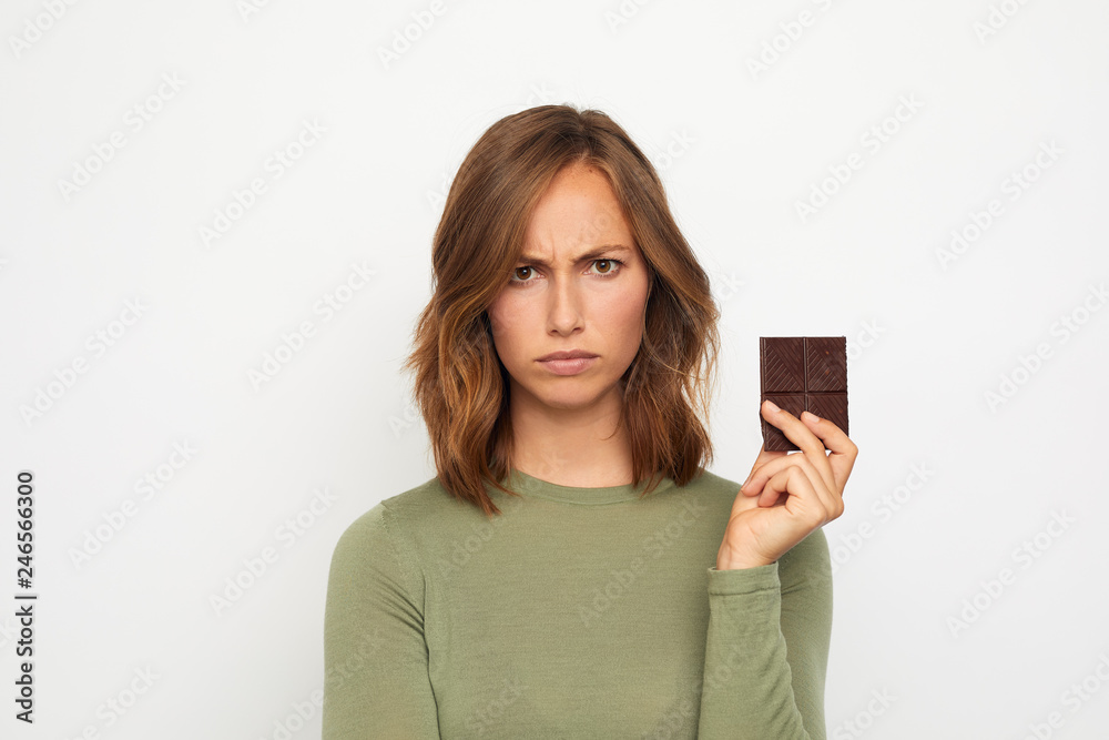portrait of young woman with chocolate mad and sad portrait of young woman with chocolate mad and sad