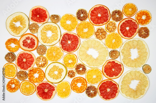 mix of different pieces of dried citrus fruit on white background