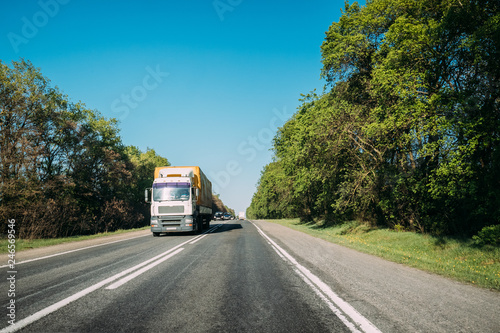 Truck On Country Road. Tractor Unit, Prime Mover, Traction Unit In Motion On Countryside Road In Europe. Business Transportation And Trucking Industry Concept