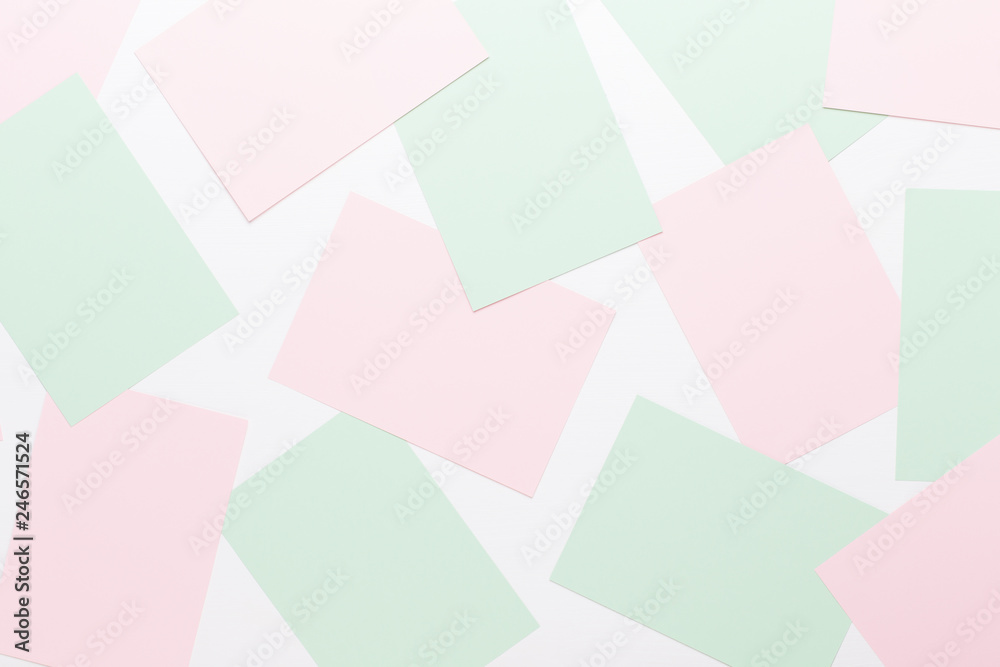 Abstract geometric background in light pastel tones from sheets of thick pale past paper.