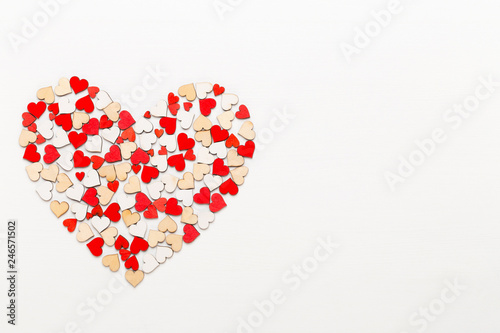 Valentines day background red hearts on white wooden background.