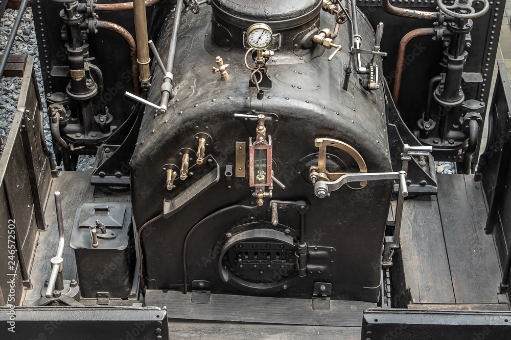 Old vintage steam locomotive cabin. Controls of a vintage steam locomotive, boiler and gauges.