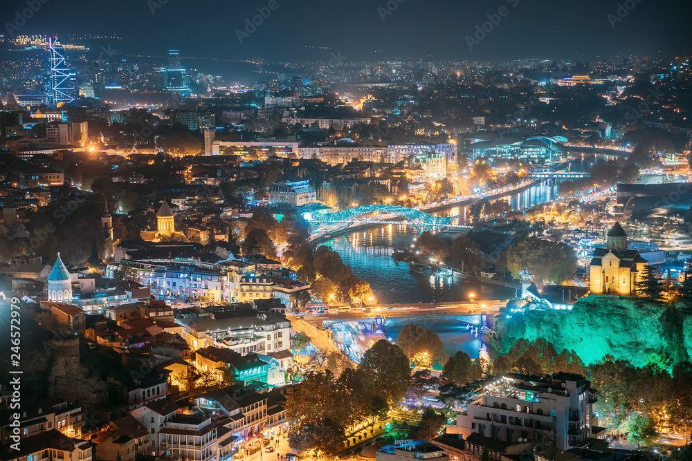 Tbilisi, Georgia. Top View Of Famous Landmarks In Night Illuminations. Georgian Capital Skyline Cityscape