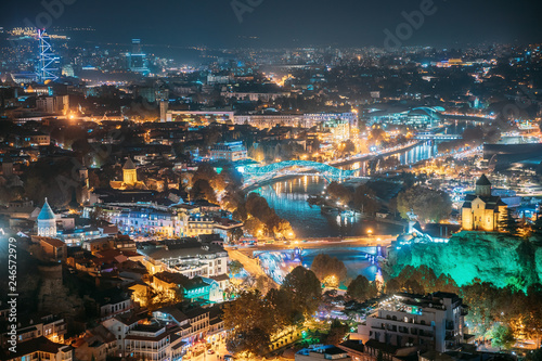 Tbilisi, Georgia. Top View Of Famous Landmarks In Night Illuminations. Georgian Capital Skyline Cityscape