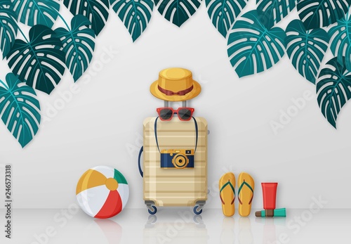 Summer travel concept with suitcase, sunglasses, hat, camera and beach ball on background with monstera leaves