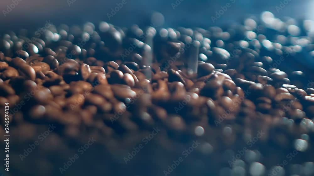 Close-up slowmo video of brown coffee beans falling down on a pile of beans Close-up slowmo video of brown coffee beans falling down on a pile of beans