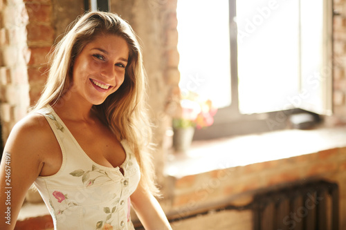 Beautiful russian girl posing for photo in the home loft studio