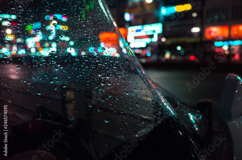 Raindrops on wet windscreen at night