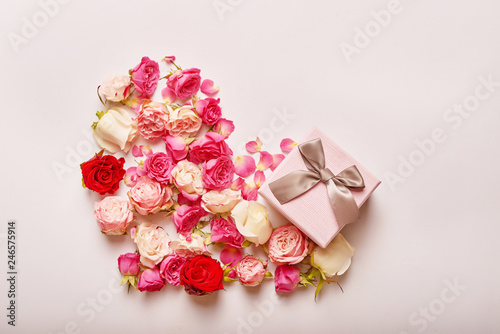 Valentine`s day composition pink gift box with flowers. Valentine card. Greeting card template. Space for text. Concept of Happy Valentine`s day. Mother`s day card. Spring flowers on pink background