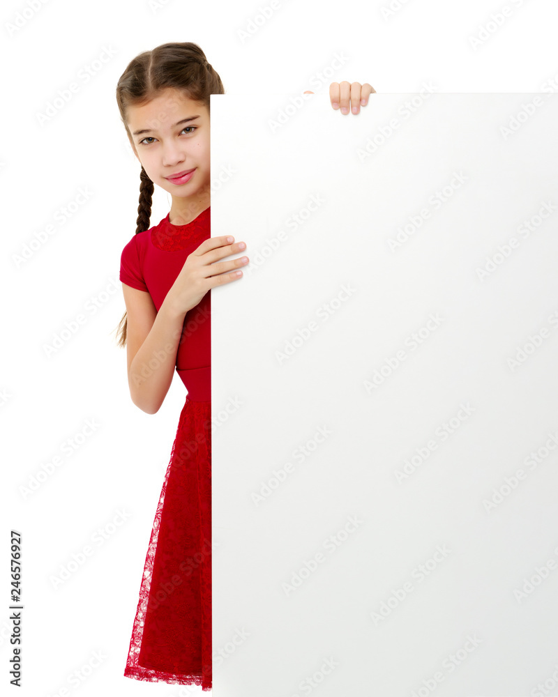 A little girl is looking from behind an empty banner. A little girl is looking from behind an empty banner.