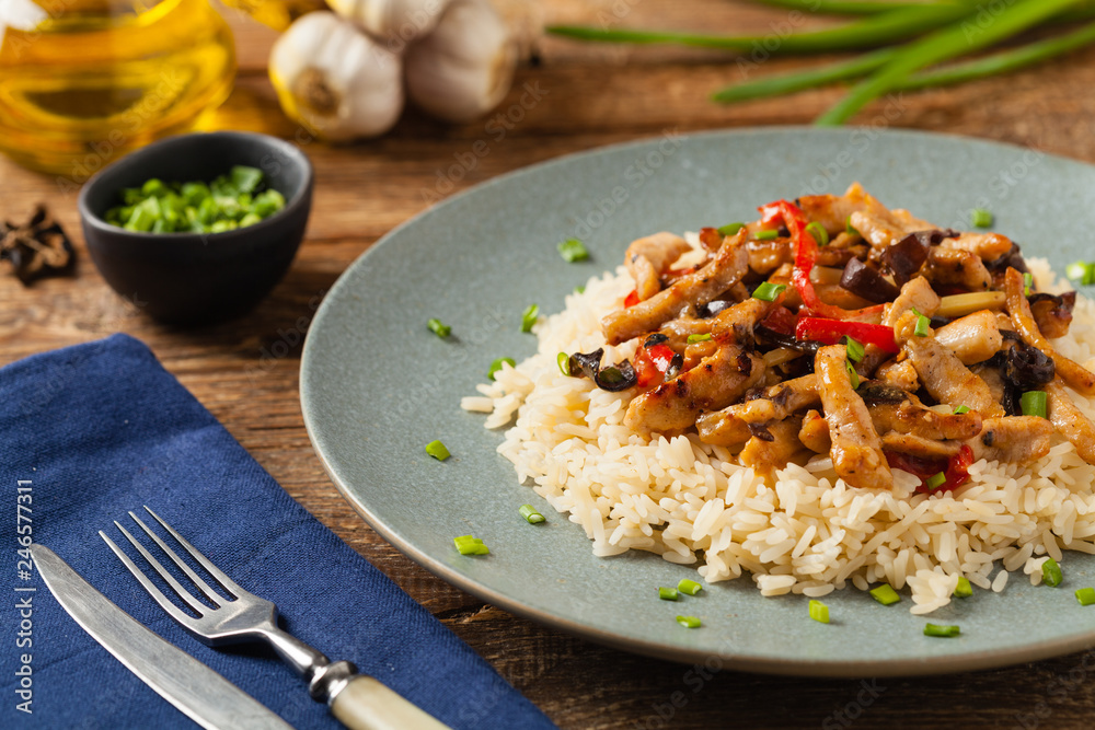 Pork chop with peppers, mushrooms and bamboo. Served with rice. Pork chop with peppers, mushrooms and bamboo. Served with rice.
