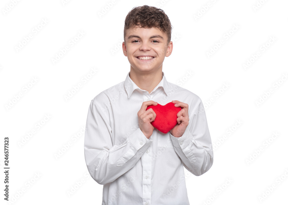 Happy Valentines Day. Cute young Teen Boy in Love with Red plush Heart in his hands. Smiling Child looking at camera, isolated on white background. Happy Valentines Day. Cute young Teen Boy in Love with Red plush Heart in his hands. Smiling Child looking at camera, isolated on white background.