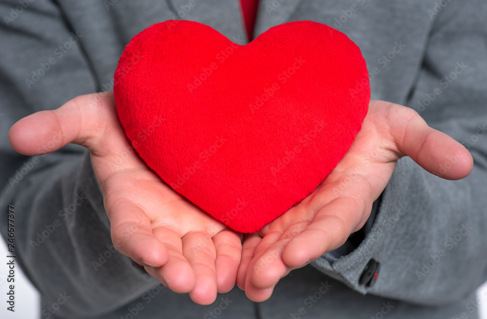 Close up, plush Heart in child hands. Happy Valentines Day. Teen Boy in Love holding red heart. Close up, plush Heart in child hands. Happy Valentines Day. Teen Boy in Love holding red heart.