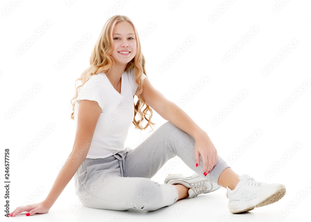 Little school girl pointing to her empty white t-shirt. Little school girl pointing to her empty white t-shirt.
