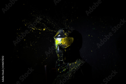  Paintball Mask zoomed in on.Splashes after direct hit to protecting mask in the paintball game.the photo as a paintball sphere is broken off at blow about a helmet.direct hit (paintball game)