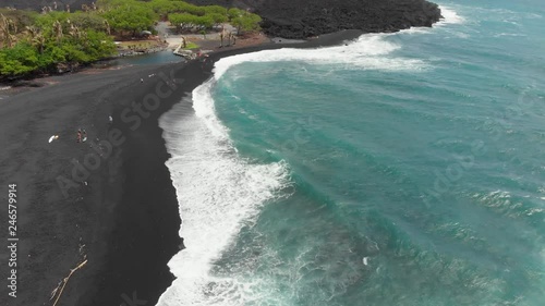 aerial footage of pohoiki bay. ( Isaac hale park. puna Hawaii. black sand beach on the east side of the big island of Hawaii. drone footage.  cooled lava in the background. photo
