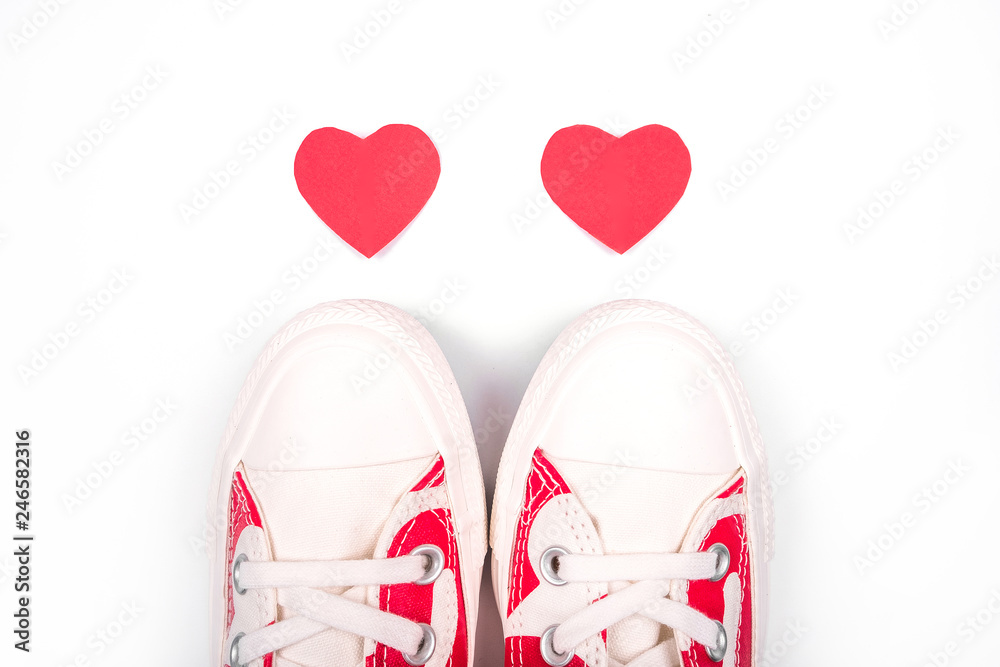 Beautiful white sneakers with hearts on the toes on white background. Concept of Love.