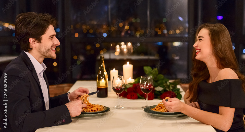 Happy couple in a restaurant celebrating Valentine day.