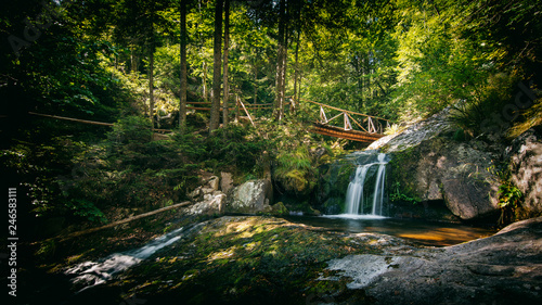 Fototapeta Naklejka Na Ścianę i Meble -  wooden bridge in the forest with waterfall