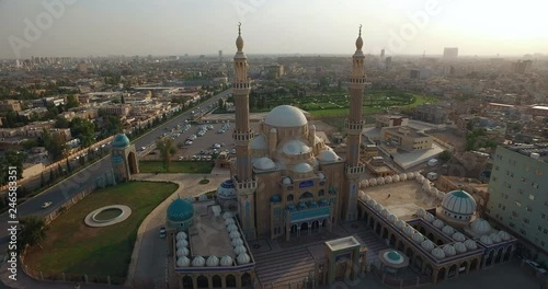 shot from left to right of a large mosque with domes and beacons photo