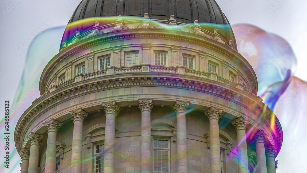 Iridescent bubble and iconic building against sky