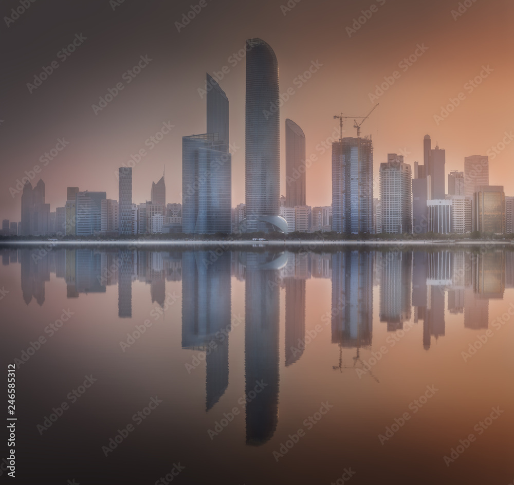 Cityscape of Abu Dhabi Skyline at misty sunrise, UAE