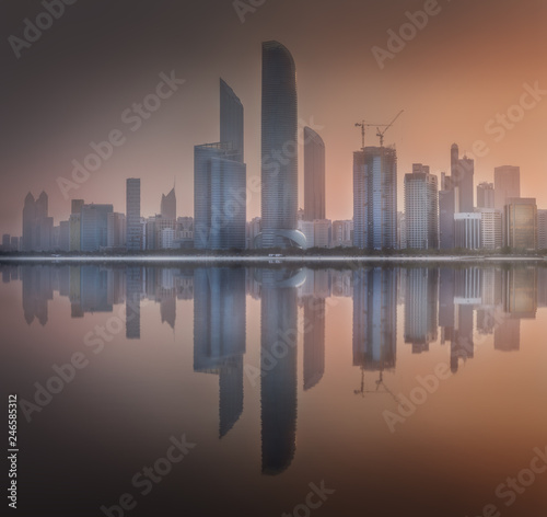 Cityscape of Abu Dhabi Skyline at misty sunrise, UAE