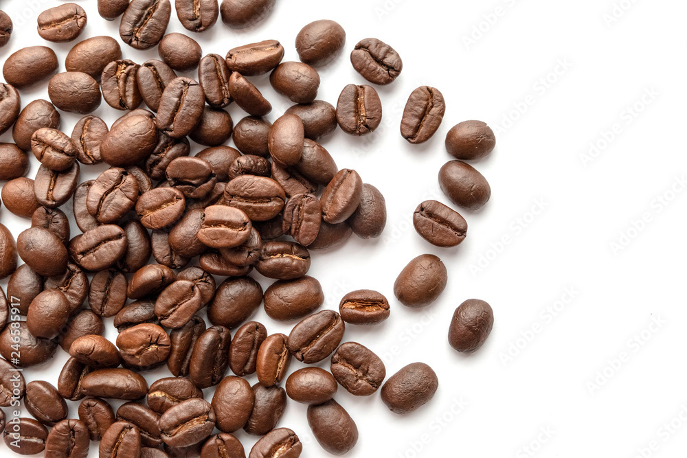 Roasted coffee beans isolated on white background. Close-up.