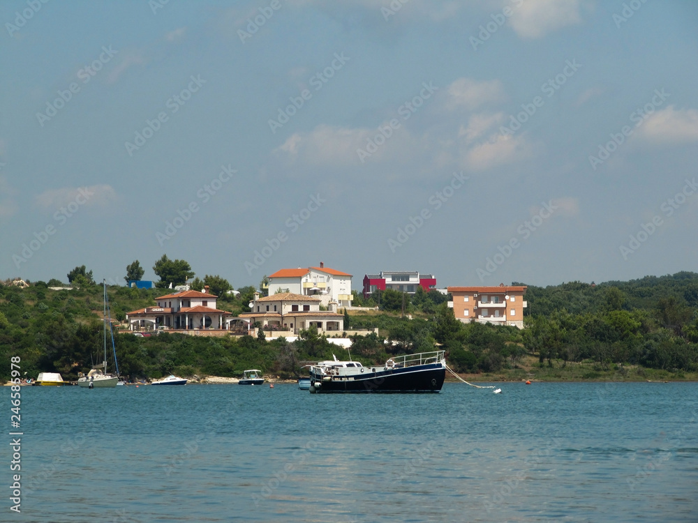 Beautiful view of the Bay where ships and boats are moored near the shore with typical European villas