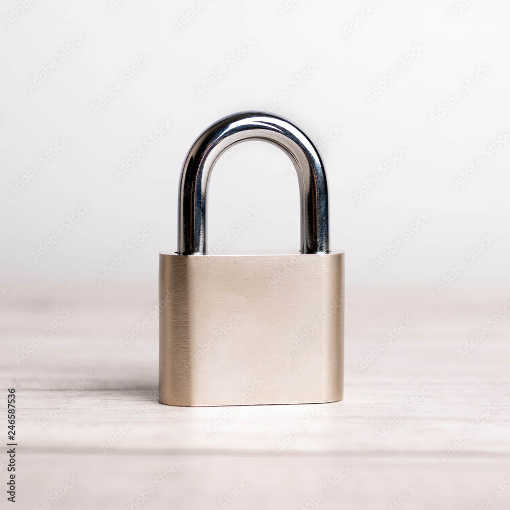 Locked padlock on a light background. Сlose-up. Locked padlock on a light background. Сlose-up.