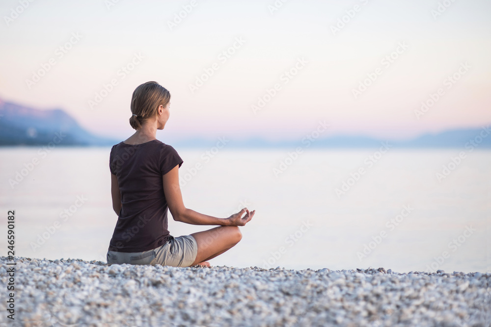 Young woman practicing yoga near the sea. Harmony and meditation concept. Healthy lifestyle Young woman practicing yoga near the sea. Harmony and meditation concept. Healthy lifestyle
