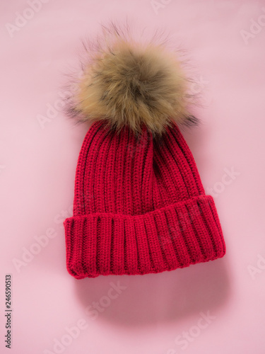 Red wool hat on pink background