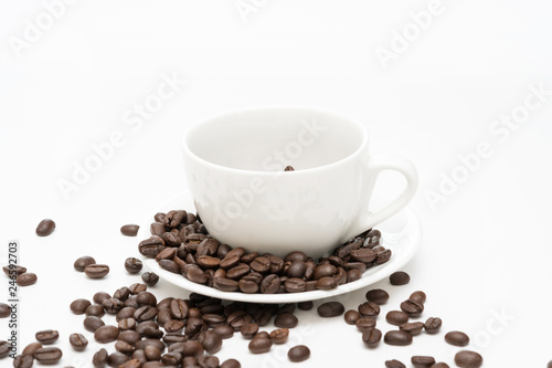 Coffee beans and white coffee cup isolated on a white background.