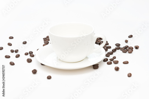 Coffee beans and white coffee cup isolated on a white background.