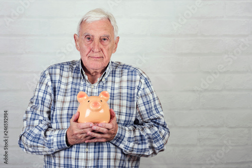 senior man with a piggybank