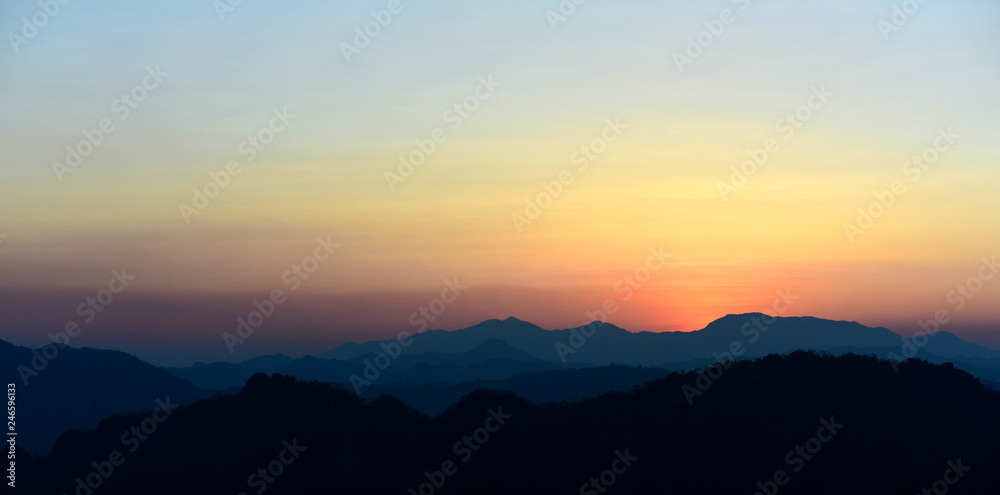 Fototapeta premium Beautiful sunrise in mountains with white fog below.Wonderful morning high in the mountains with clouds below the mountain tops in the valleys. Colorful wild nature landscape.