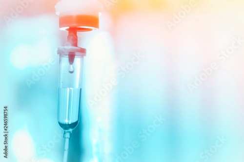 Saline iv drip fluid intravenous drop  hospital room,medical concept,treatment emergency and injection drug infusion care therapy chemotherapy, flare light background 