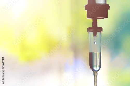 Saline iv drip fluid intravenous drop  hospital room,medical concept,treatment emergency and injection drug infusion care therapy chemotherapy, flare light background 