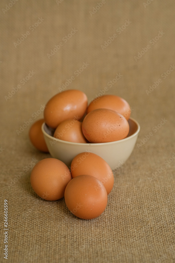A dozen of eggs shot with gunny sacks as background.
