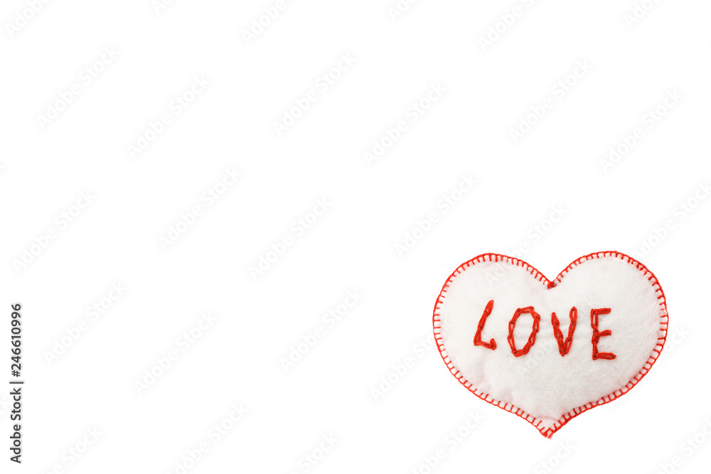 small soft homemade toy in the form of a heart for Valentine's Day on a white isolated background